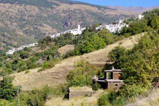 Blick in die Landschaft mit weißem Dorf im Hintergrund