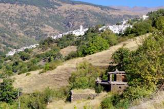 Blick in die Landschaft mit weißem Dorf im Hintergrund