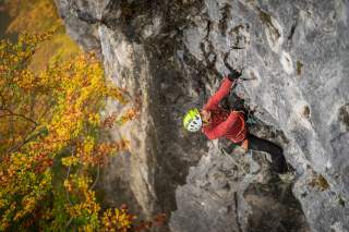 Kletterin klettert an der Felswand.
