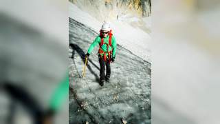 Mensch läuft mit Gletscherausrüstung Gletscher hoch