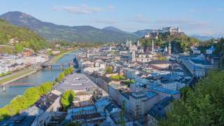 Blick über die Dächer Salzburgs von der Stadtalm aus. Links im Bild die Salzach, im Hintergrund der Gaisberg mit Sendeantenne.