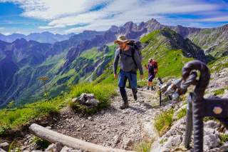 Zwei Personen steigen Bergsteig hinauf