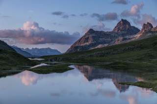 Abendstimmung an Bergsee mit Gipfeln im Hintergrund