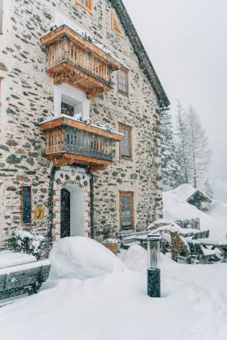 Gasthaus aus Stein im Schneegestöber