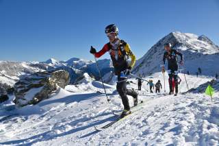 Skimo Athleten auf schneebedeckten Gipfeln unterwegs