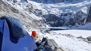 Zelt im Vordergrund, im Hintergrund die verschneite Gebirgslandschaft Patagoniens.