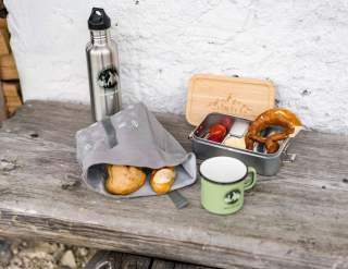 Brotzeit auf Bank vor Hütte