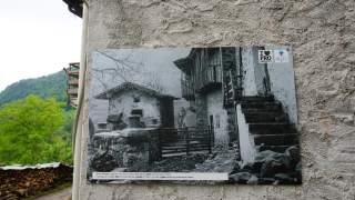 Bild auf Hauswand in Prossenicco: Es zeigt einen typische Bauernhof aus den 1960er Jahren.